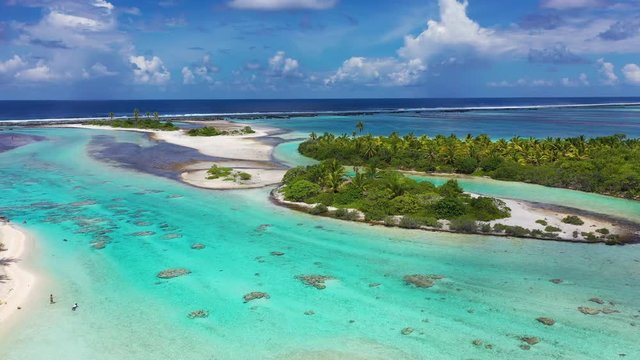 Rangiroa aerial drone video of atoll island motu and coral reef in French Polynesia, Tahiti. Amazing nature landscape with blue lagoon and Pacific Ocean. Tropical island paradise in Tuamotus Islands.