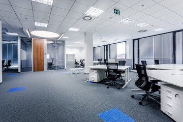 Part of ordinary office room decorated in modern style with meeting room,large windows with...