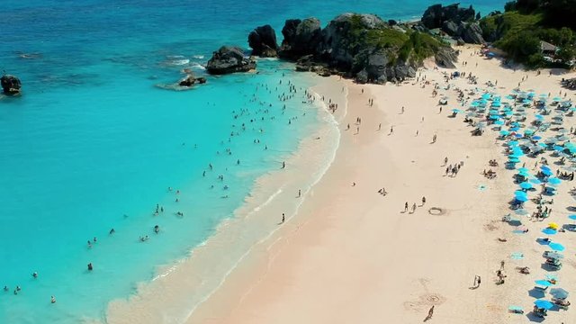 Aerial Tilt Downward: Smooth Sand of Bermuda Beach Visited by Tourist in Spanish Point, Bermuda