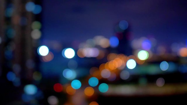 High angle view of night traffic light in modern city from moving car windows, Shanghai night urban street cars river and skyscraper lights, defocused and soft bokeh, 4K movie, slow motion.