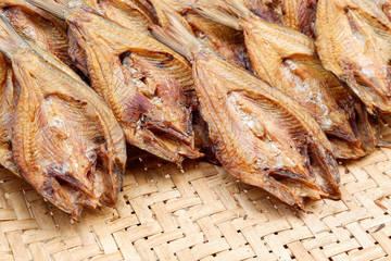 Making dried fish / dry salted fish on threshing basket background