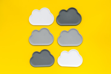 Obraz premium cloud service concept with clouds on yellow background top view