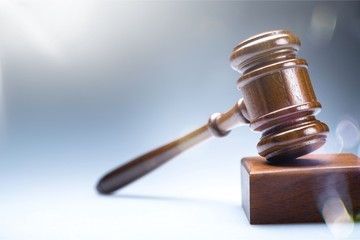Wooden gavel on wooden table, on  background