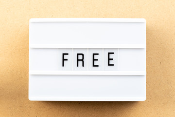 Light box with word free on wood background