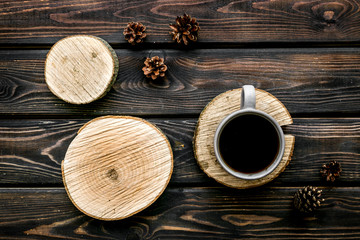 coffee on sawcut and pine cone pattern for blog on wooden background top view
