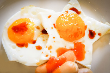 breakfast egg star shaped on plate and hot dog with sauce