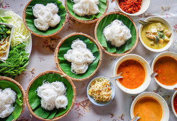 Set of thai rice noodles fish curry  sauce with various soups on bowl and fresh vegetable