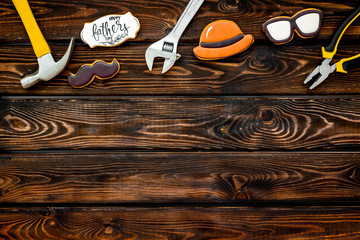 moustache, hat, glasses, tools and copy for Happy Father Day party on wooden background top view copy space