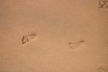 Fototapeta na wymiar cildren footprints in the sand 