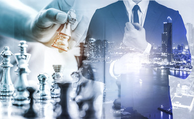 The double exposure image of the businessman standing overlay with chess game image. the concept of...