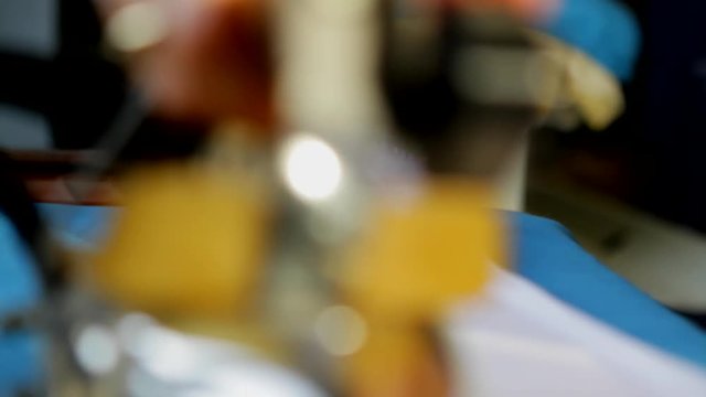 Ironing a white shirt. Electric iron use inside a laundry. Hands straighten the shirt.