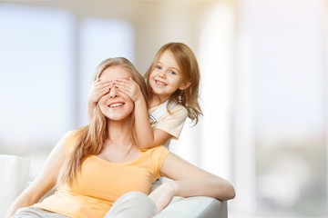 Portrait of happy mother and daughter holding  flowers