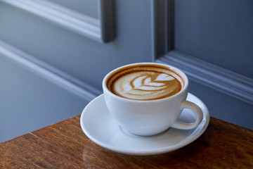 Cup of coffee latte art on the wood desk
