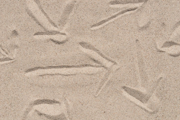 arrow sign on natural sand texture background