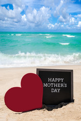 Happy Mothers day beach background with black board and heart