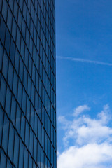 Fototapeta na wymiar sky and clouds reflected in windows of modern building