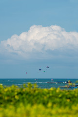 Travelers playing colorful parasailing at Pattaya, Thailand.