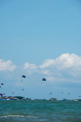Travelers playing colorful parasailing at Pattaya, Thailand.