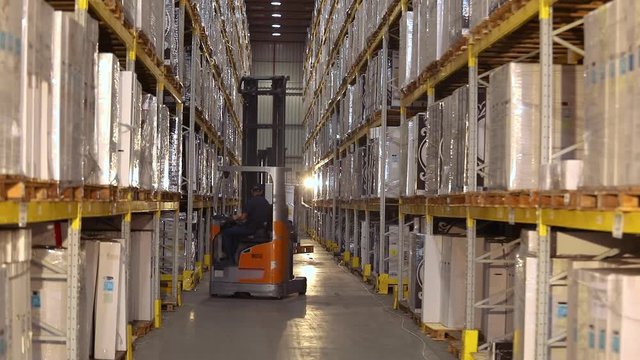 Forklift in a large modern warehouse, work of forklifts in a warehouse, workflow in a warehouse