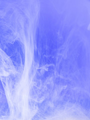 Droplet of lilac paint dissolving into water, close up view. Blurred background. Acrylic clouds moving in water, abstract background. Lilac ink mixing with liquid, abstract pattern