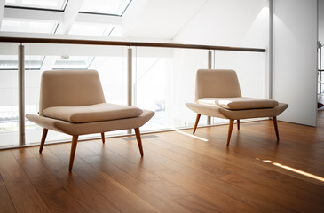 Modern minimalistic interior. Living room with two armchairs. Large windows in the roof