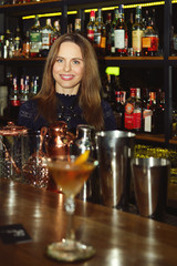 Bartender girl serving coctail to a customer