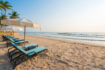 Sun umbrellas and chairs on tropical beach