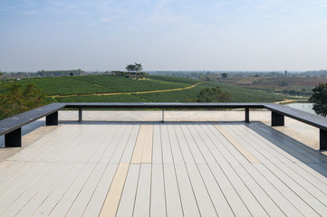 Bench on wooden patio of roof with tea plantation