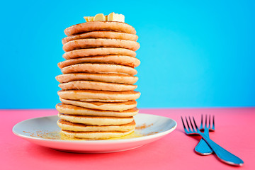 stack of pancakes on pink and blue background