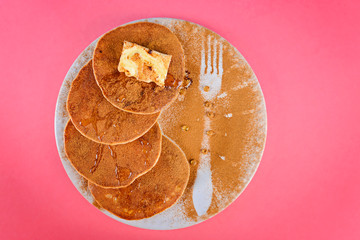 Pancakes in white plate with cinnamon and caviar made from honey.