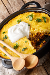 Perfect Tamale Pie Recipe - Rich zesty beef filling topped with fluffy corn bread closeup. vertical