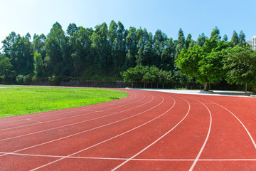 Outdoor track and field stadium runway under the blue sky.