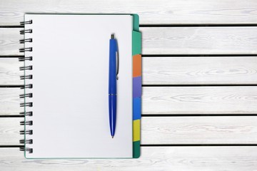 Open blank notebook and pen on a white background