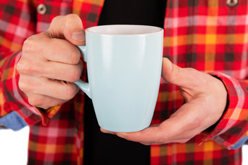 A man holding blue mug