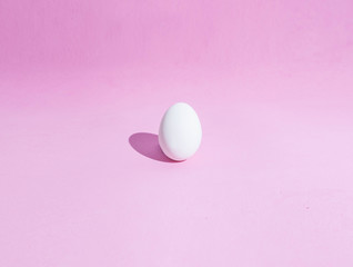  Food background made of white Easter eggs on a pink backdrop. Design, visual art, minimalism, top view, flat lay, hard light, hard shadows.