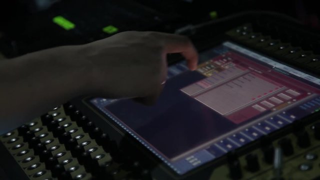 remote recordists closeup. Hand adjusts sound effects. Electric machine on table for working of sound designer or club dj at party in nightclub. Occupation for modern lifestyle, objects for listen at 