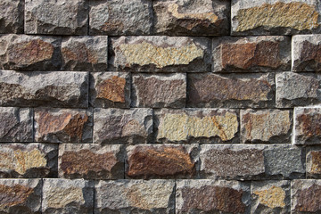 Naklejka premium Background, texture, masonry from a multi-colored natural stone