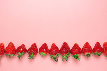 Fresh strawberries on pink background