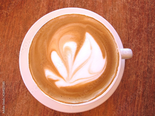 Flat White Coffee in white cup on timber cafe table