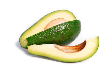 Avocado fruit sliced into slices on a white isolated background