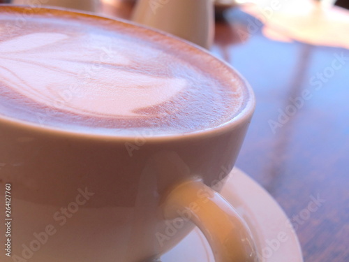 Macro Coffee in Cup with soft focus cafe background