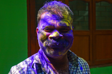 Portrait Of A Indian Man With Colour On His Face On Festival Of Holi