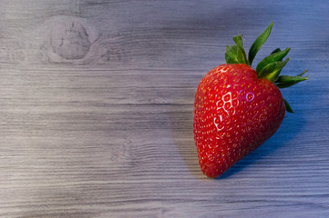 Strawberries on vintage wooden background