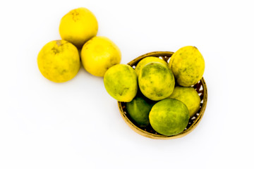 Raw organic fresh lemon isolated on white in a basket.