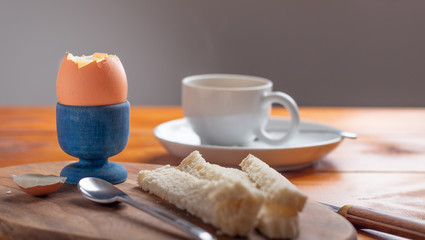 boiled egg for breakfast with white bread and coffee