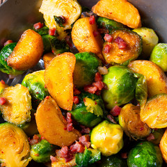Brussels sprouts potato pan with bacon in rustic style