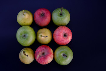 Still life on a black background.Fruit on black background.Apples pears kiwi grapes lemon.Healthy and healthy food. Bright fruit.Healthy diet. Natural food.