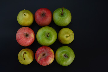 Still life on a black background.Fruit on black background.Apples pears kiwi grapes lemon.Healthy and healthy food. Bright fruit.Healthy diet. Natural food.