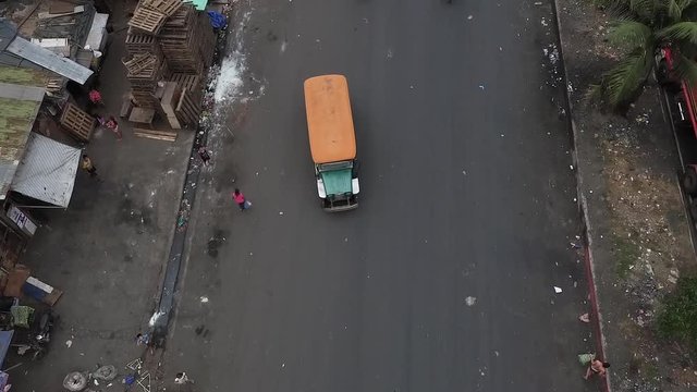 Aerial Shot Of A Jeepney Travelling On A Busy, Dirty Road Of Manila Philippines