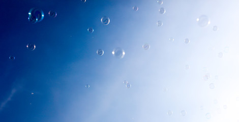 Soap bubbles fly in the blue sky